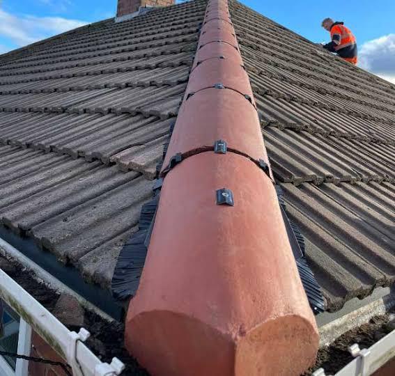 Ridge tile installation with dry ridge system on pitched roof