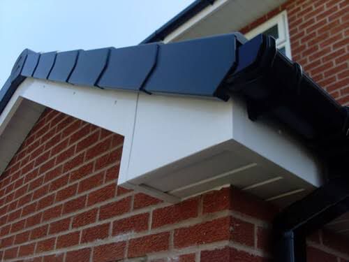 Fascia and soffit installation with new guttering on brick house