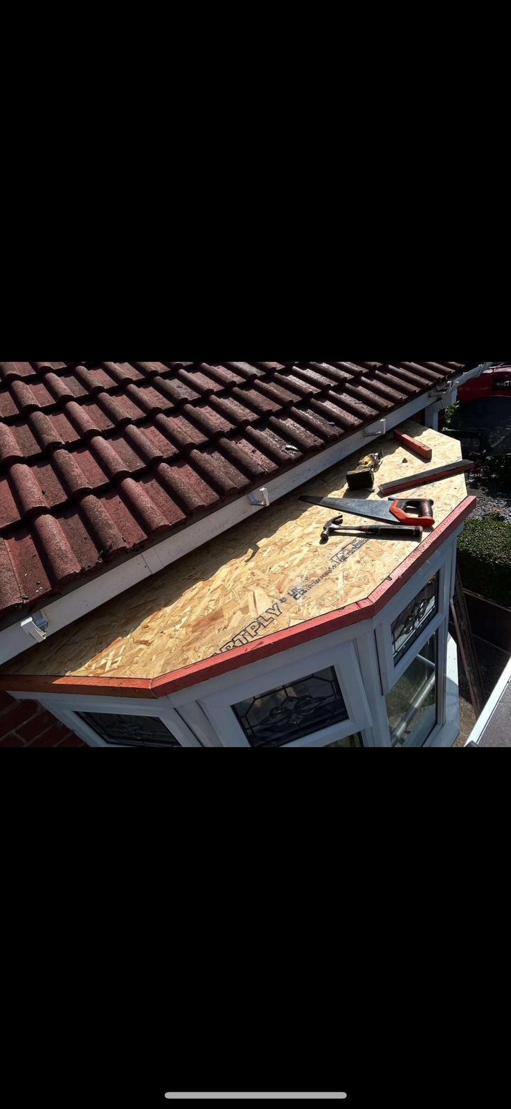 Professional gutter cleaner using a vacuum-pole system to clear leaves from gutters in County Durham